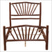 traight-on view of the fully assembled Fireside Lodge Hickory Log Sunburst Bed frame without a mattress showing the sunburst log pattern on both headboard and footboard