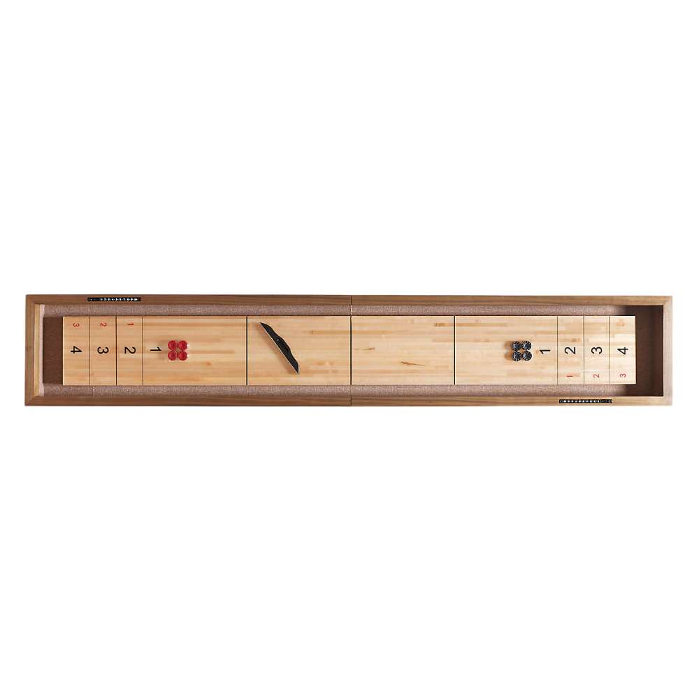 Walnut Crate & Barrel Shuffleboard seen from directly above against a white background with scoring numbers 4, 3, 2 and 1 at each end, four red pucks at one end, four black pucks at the other and the table brush across the middle