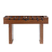 Walnut Wood Crate & Barrel Modern Wood Foosball Table seen straight from the front with black player figures on chrome rods and two wide slab legs