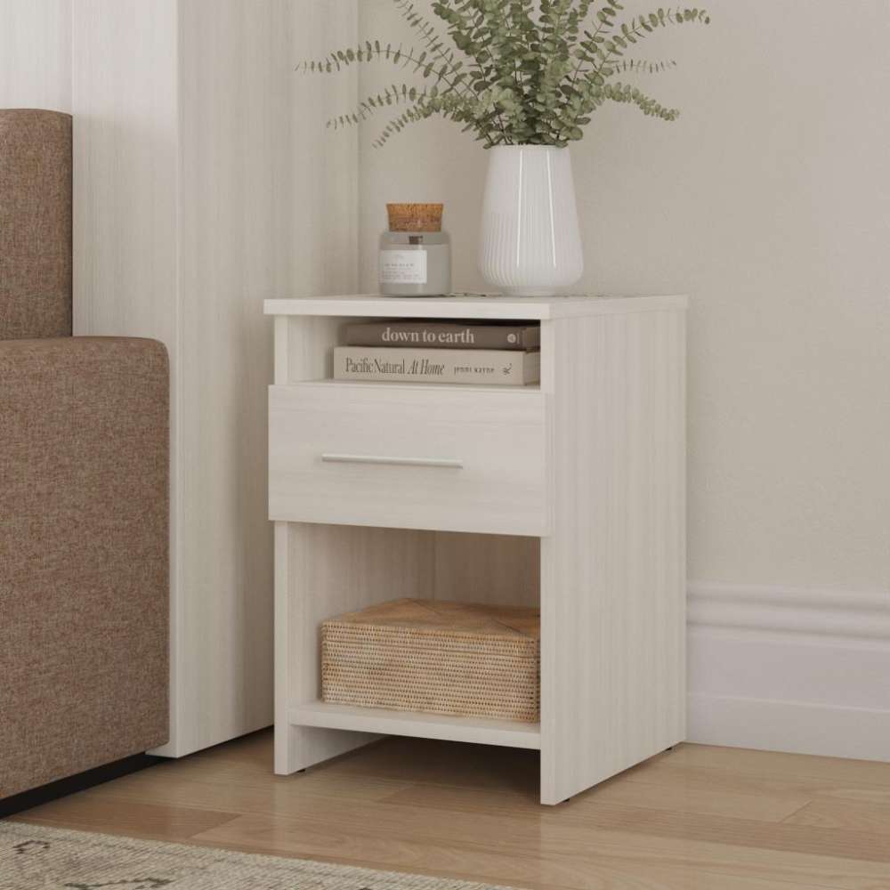 White Ash Inovabed Wall Bed with Sofa and Two Nightstands showing one nightstand beside the sofa, styled with a vase of greenery, a candle, books in the open cubby and a woven basket below