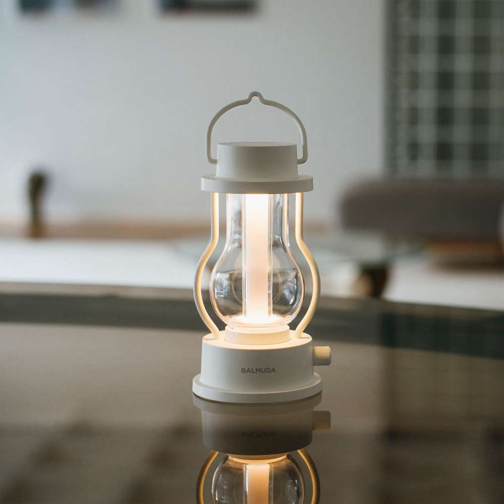White Crate & Barrel Balmuda LED Rechargeable Outdoor Lantern shown on a plain background, a rechargeable lantern that runs 3 to 50 hours per charge