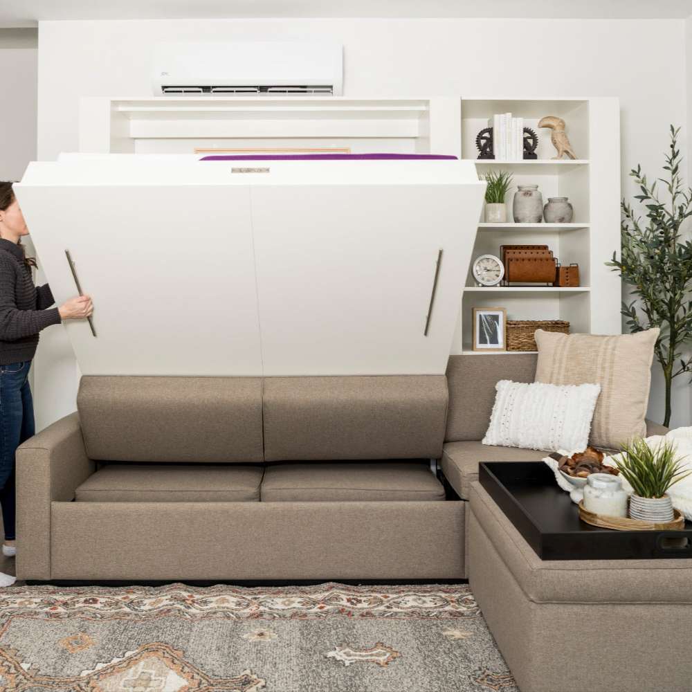 White Inovabed Wall Bed with Extended Sofa photograph of a person pulling the bed down from the closed sofa position