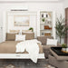 White Inovabed Wall Bed with Extended Sofa photographed room with the bed lowered, a throw across the mattress and an ottoman beside it