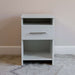 White Inovabed Wall Bed with Sofa and Two Nightstands showing one nightstand head-on against a wall in a carpeted room