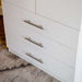 White Inovabed Wall Bed with Sofa and Wide Flex Cabinet in close-up on the three Wide Flex Cabinet drawer fronts and their slim bar pulls