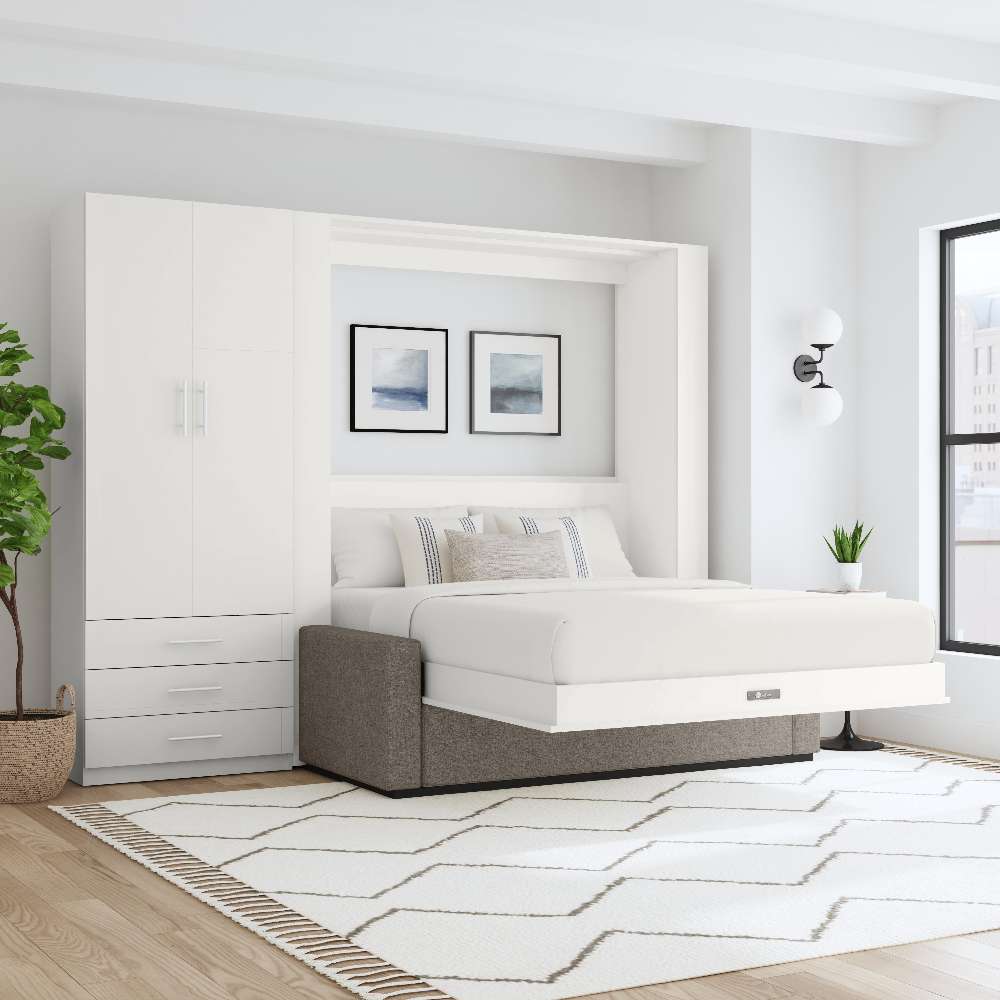 White Inovabed Wall Bed with Sofa and Wide Flex Cabinet opened in a bright room beside the Wide Flex Cabinet, with white bedding, a gray sofa base and two framed prints above the headboard