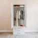 White Inovabed Wall Bed with Sofa and Wide Flex Cabinet showing the Wide Flex Cabinet open in a room with clothes hanging on the rod, folded items on the top shelf and red shoes on the base