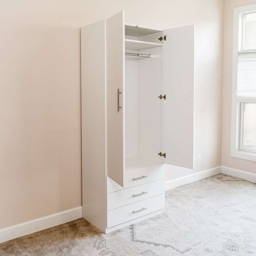 White Inovabed Wall Bed with Sofa and Wide Flex Cabinet showing the Wide Flex Cabinet with one door open beside a window in a carpeted room