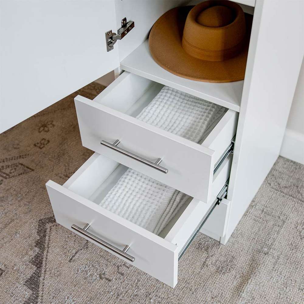 White Inovabed Wall Bed with Table and Two Narrow Flex Cabinets in close-up with two Narrow Flex Cabinet drawers pulled open on folded towels and a hat resting above