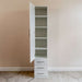 White Inovabed Wall Bed with Table and Two Narrow Flex Cabinets showing one Narrow Flex Cabinet with its door open on empty shelves above three closed drawers