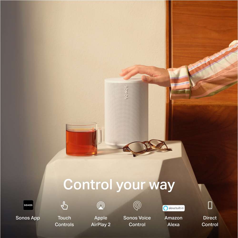 White Sonos Era 100 Next-Gen Smart Speaker a hand touching the speaker top on a bedside table with the words Control your way and icons for Sonos App, Touch Controls, Apple AirPlay 2, Sonos Voice Control, Amazon Alexa and Direct Control
