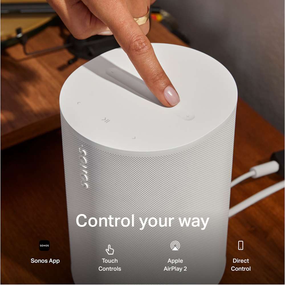 White Sonos Era 100 SL Compact Wireless Speaker close-up of a finger tapping the top controls on a wooden surface with the words Control your way and icons for Sonos App, Touch Controls, Apple AirPlay 2 and Direct Control