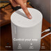 White Sonos Era 100 SL Compact Wireless Speaker close-up of a finger tapping the top controls on a wooden surface with the words Control your way and icons for Sonos App, Touch Controls, Apple AirPlay 2 and Direct Control