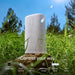 White Sonos Play Portable Bluetooth Speaker standing on a rock in tall grass under a blue sky with the words Control your way and icons for Sonos App, Touch Controls, Apple AirPlay 2, Sonos Voice Control, Amazon Alexa and Direct Control