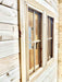 wood-framed window exterior of a Sawmill Structures BlueWater Bungalow 160 Garden Room, set against horizontal pine siding