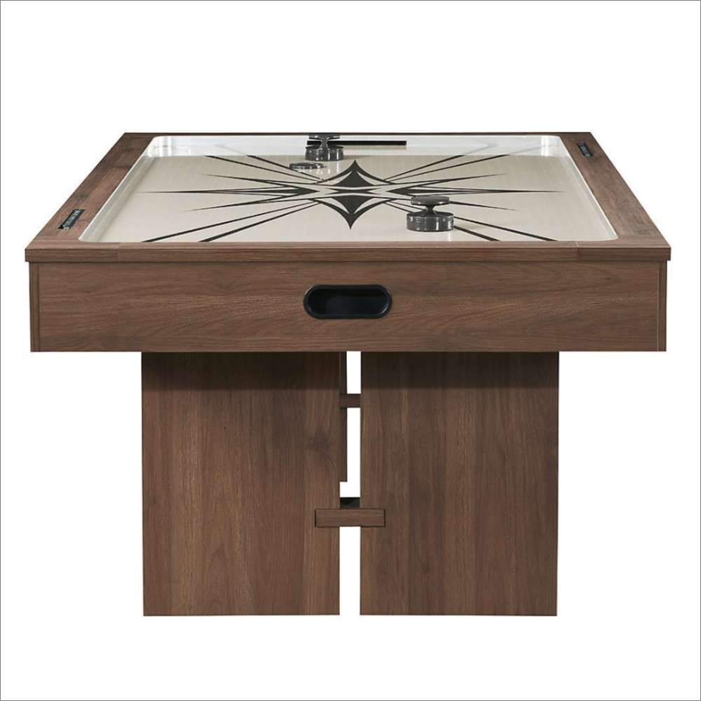 Woodgrain Crate & Barrel Air Hockey Table seen straight from the end on a white background with the oval goal opening in the cabinet, the starburst field above and two slab legs joined by a low stretcher