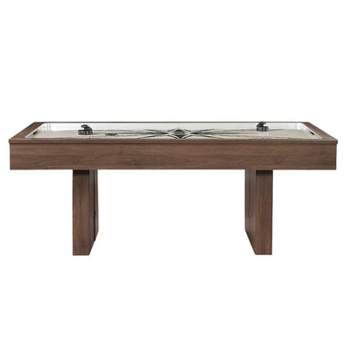 Woodgrain Crate & Barrel Air Hockey Table seen straight from the side on a white background showing the full length of the cabinet, the cream field with two black strikers and two angled slab legs