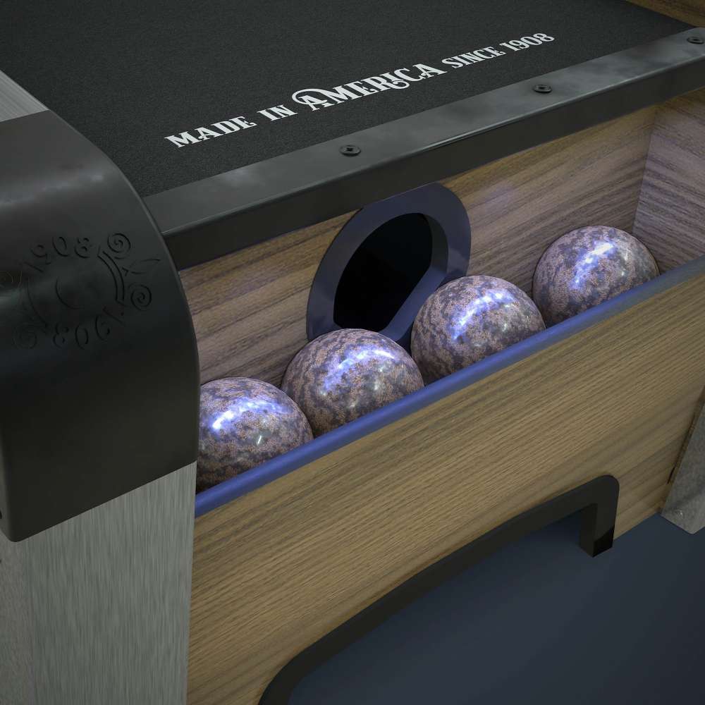 Woodgrain Crate & Barrel Skee-Ball Home Arcade Premium in close up on the ball return holding four speckled balls under blue light beside the words made in America since 1909
