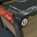 Woodgrain Crate & Barrel Skee-Ball Home Arcade Premium in close up on the front corner with the round Skee-Ball badge, control buttons and a red lit ball return holding balls